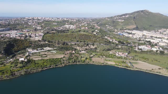 Lake in south of italyDiscover the tranquil beauty of a Southern Italian lake captured from above by a drone: serene waters, lush greenery, and quaint lakeside villages create a mesmerizing vista.