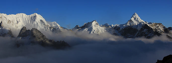Mount Ama Dablam and other high mountains reaching out of a sea of fog, Nepal.
