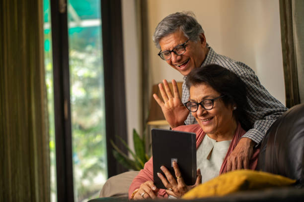 istock Elderly happy couple talking on video call at home 2148040276