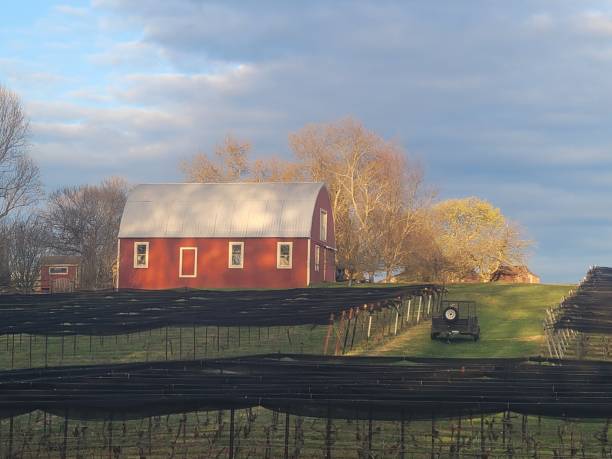 istock Red barn and farm land 2148040402