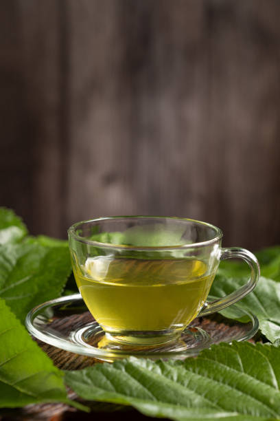 istock Mulberry Tea. Glass cup of mulberry leaf tea. 2148041404