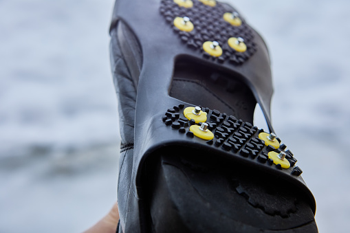 Grip cleats for footwear of traction device on slicked ice, slippery hard packed snow on wintry city sidewalks.