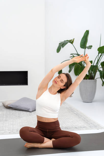istock Young woman doing exercise on a mat during yoga practice. 2148043113