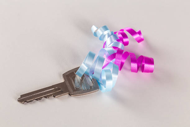 Close up of an old fashioned key stuck in a white key hole