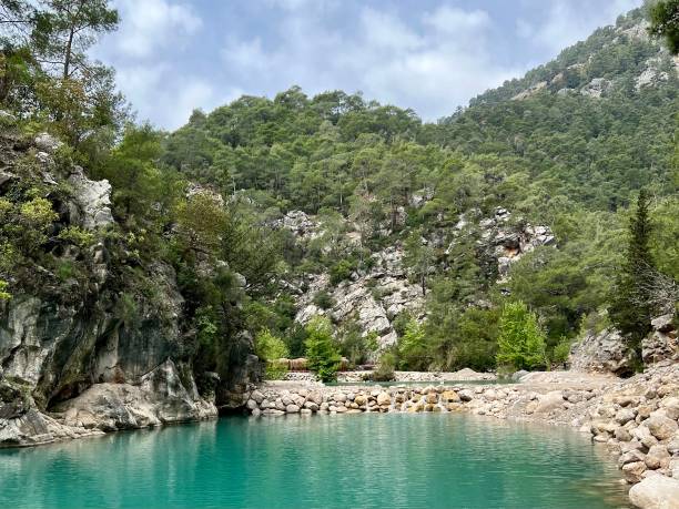istock Blue lake surrounded by mountains and trees 2148044403