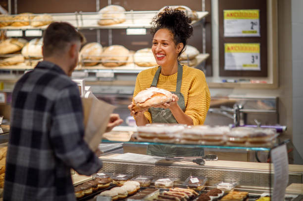 istock Mature Hispanic Woman Assisting Customer in Bakery 2148044595