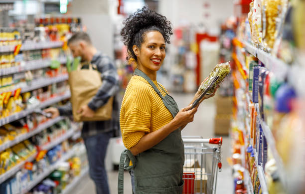 istock Efficient Shopping Assistant Aiding Customers in Grocery Store 2148044598