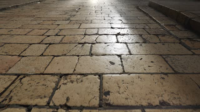 Camera movement along the ancient road of the old city of Jerusalem in the early morning