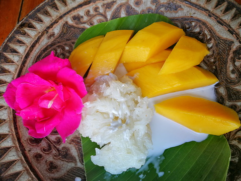 Mango Sticky Rice It is a local dessert in many Southeast Asian countries. It is popular to eat during the summer because it is the mango harvest season. Made from sticky rice, mango and coconut milk.