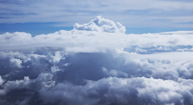 View from airplane flying through Cumulous clouds
