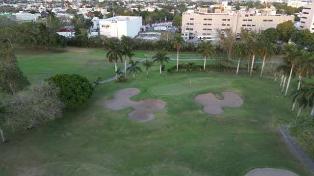 Aerial view receding, revealing the lush green golf course at Club Campestre Tampico.