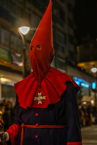 Valladolid, Spain - March 29, 2024: Penitent looks hooded in Valladolid procession