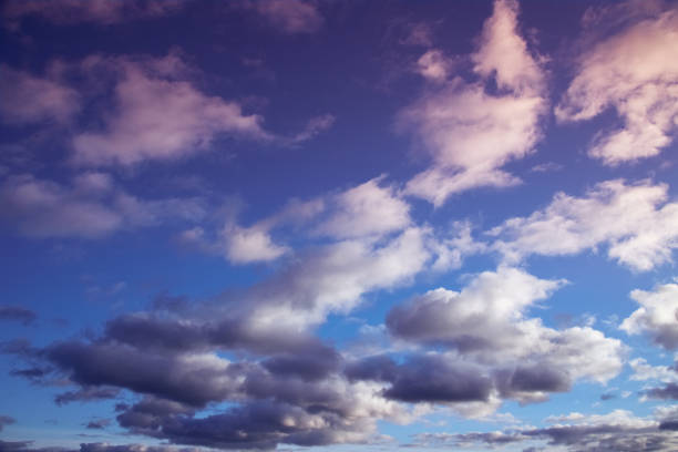 Soft evening sunlight on cumulus clouds in the sky