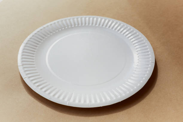 istock A white paper plate lies on a beige table 2148048144