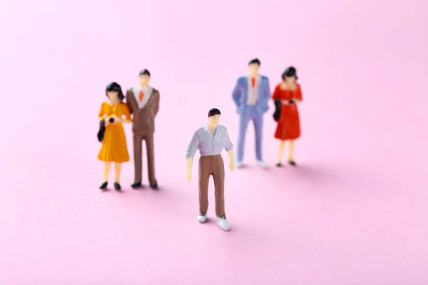 istock Miniature people on pink background 2148048983