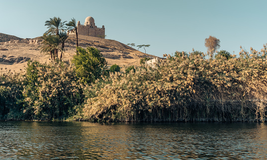 Nile bank oasis landscape with  Mausoleum of Aga Khan n the background