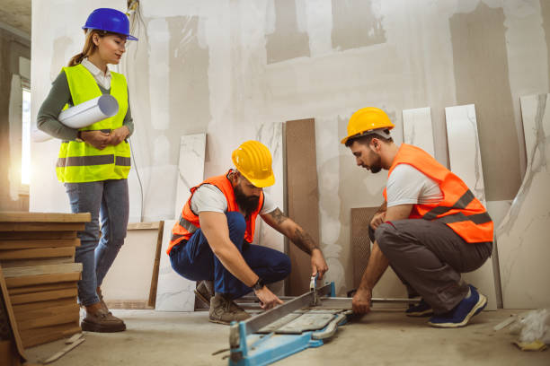 istock Tilers at construction site, worker cuts a large slab of tile during the construction of a house, floor tile cutting equipment. 2148049419