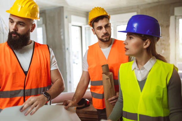 istock Construction team planning a building blueprint project on site with collaboration for architect innovation. Architecture, design and engineers with teamwork for successful 2148049421