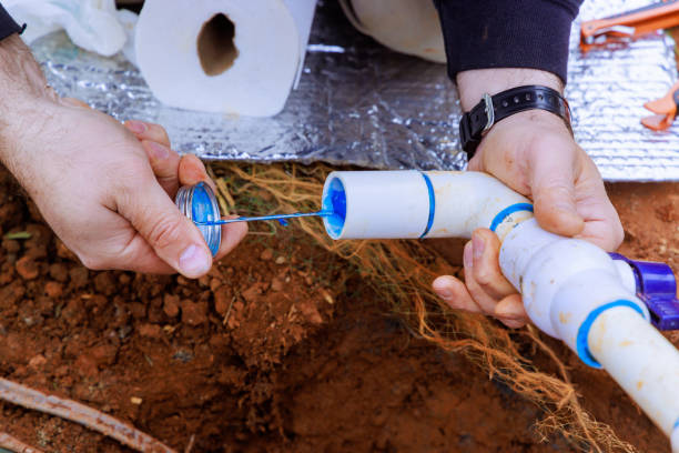 istock Glue applied to pvc pipe by a plumber before it is glued 2148049463