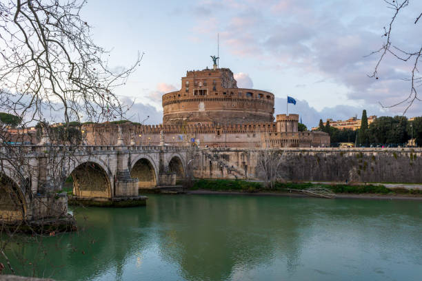 Rome, Italy - March 2, 2024: Bridge and Mausoleum Castel Sant Angelo at sunset in Rome, Italy