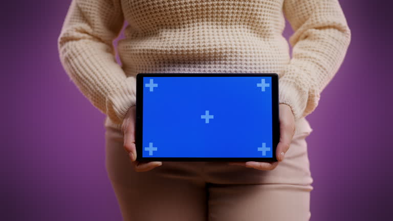 Close-up of woman holding a tablet with pre-keyed blue screen for your text