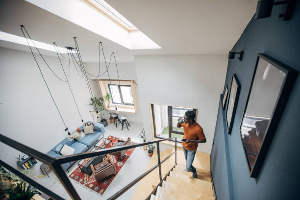 Black man in modern apartment and using smart phone.