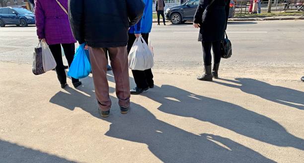 istock Waiting people at a public transport stop. 2148050793