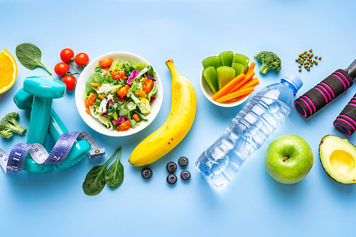 Healthy eating and exercising banner. Blue background. High resolution 42Mp studio digital capture taken with SONY A7rII and Zeiss Batis 40mm F2.0 CF lens