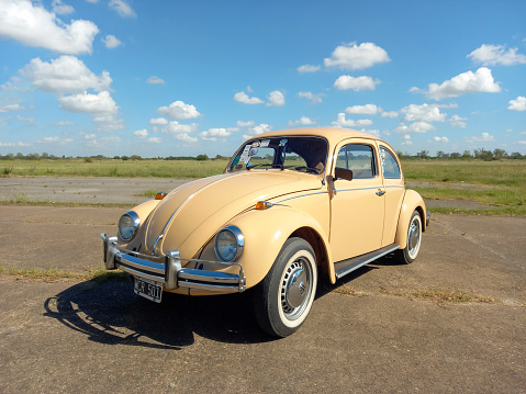 Morón, Argentina - Apr 7, 2024: Old cream Volkswagen T1 Type 1 Beetle Bug at a classic car show in an airstrip. Copy space