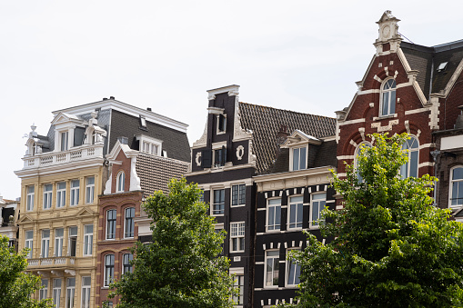 Historic facades of canal houses in the city center of Amsterdam.