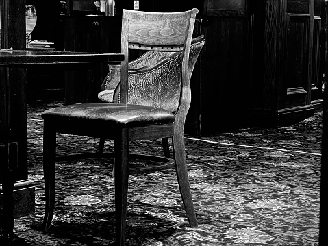 An empty wooden chair in an empty bar establishment in Nottingham