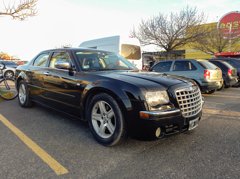 Buenos Aires, Argentina - May 28, 2023: Shiny black 2007 Chrysler 300C sedan sold in USA as Dodge Magnum at a classic car show in a parking lot