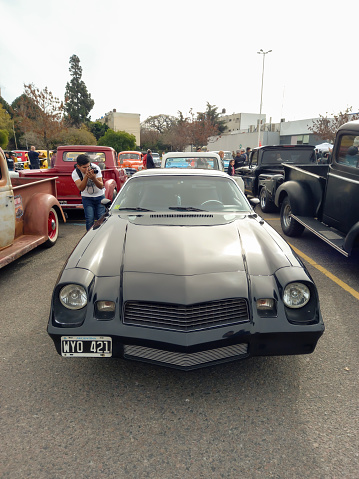 Buenos Aires, Argentina - Jun 4, 2023: Shot of a black sport muscle 1979 Chevrolet Camaro Z28 coupe at a classic car show in a parking lot. Front view. Copy space