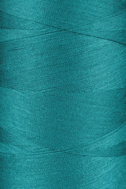 istock Texture of turquoise color threads in spool close up, macro 2148056363