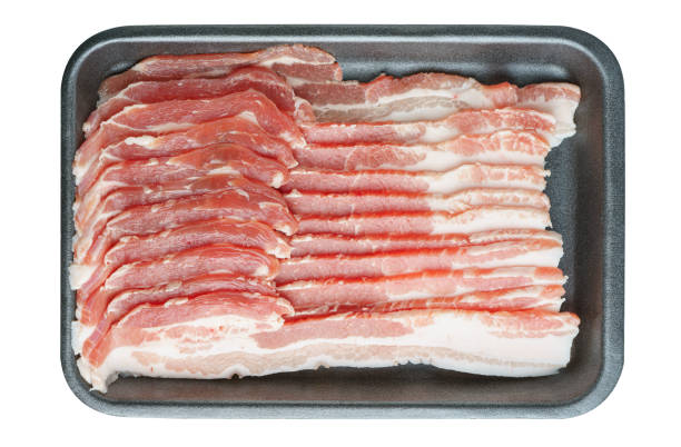 Raw pork bacon in black plastic pack isolated on white background. Streaky brisket slices, fresh thin sliced bacon, food ingredient
