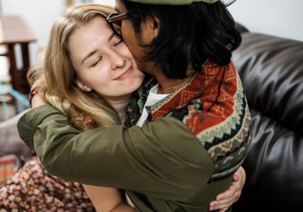istock Affectionate young couple hugging on a living room sofa 2148062022