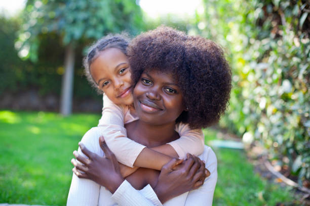 istock Spring portrait African mother embracing her child in backyard 2148064843