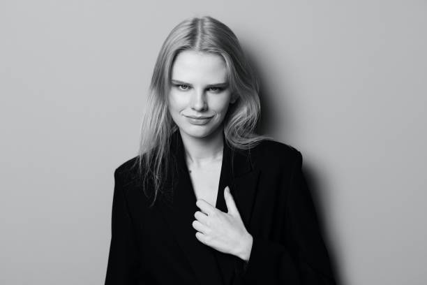 istock Sexy expressive professional model touching her jacket and looks at camera. Beautiful blonde lady posing at studio. Good offer for fashion brands. Minimalistic art style 2148064862