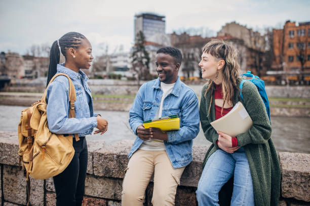 istock Diverse students laughing and conversing outdoors 2148065611