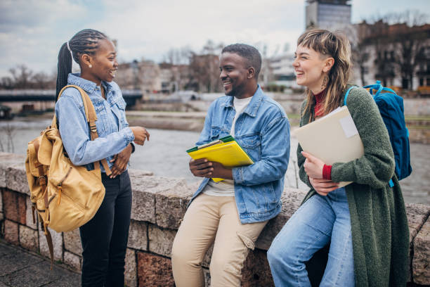 istock Multicultural students laughing and discussing outdoors 2148065645