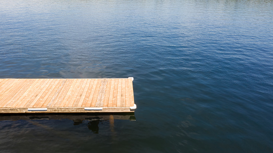 Tranquil lakeside scene with wooden dock at a Muskoka cottage in Canada
