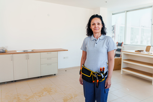 Architect woman, clipboard and happy on construction site in industry, planning and inspection. Engineer, architecture and construction worker smile at industrial workplace in building, house or home
