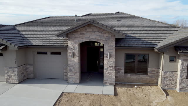 Drone View Exterior Newly Constructed Executive Modern Home with Stucco, Cultured Stone and Slate Roof