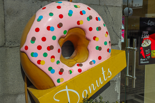 Armenia, Yerevan - March 8, 2024: Large decorative donut at the entrance to the cafe
