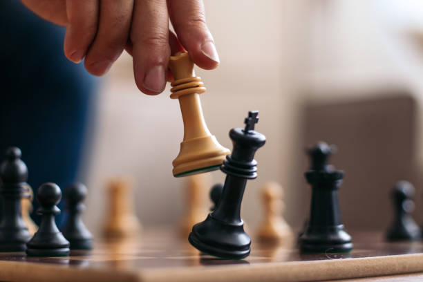 Chess game at home. Checkmate. Checkmate. Hand of an unrecognizable man playing chess defeating his opponent's king checkmate stock pictures, royalty-free photos & images