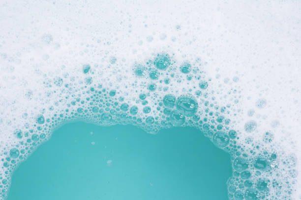 istock Detergent foam bubble on water. Blue background, Soap sud 2148071557