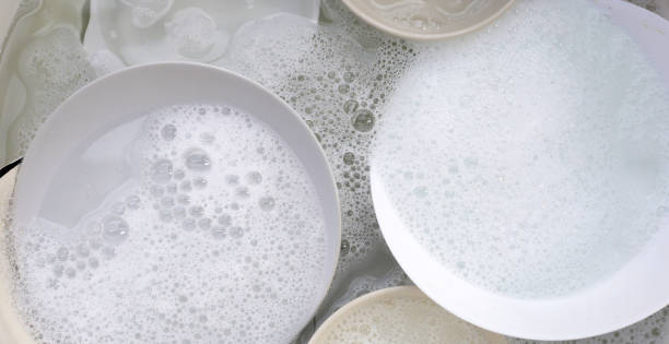 istock Dish washing, Dirty dishes soaking in kitchen sink. 2148071810