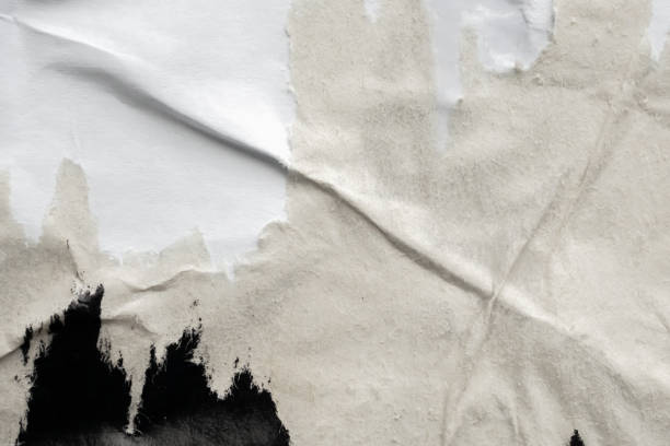istock Old grunge ripped torn black paper poster surface texture background 2148072038