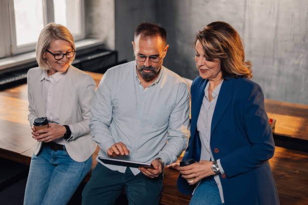 istock Mature businesspeople with tablet collaborating on a business plan. 2148072422