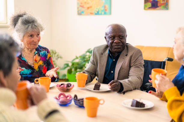 istock Retired care home residents chatting around a table 2148073211